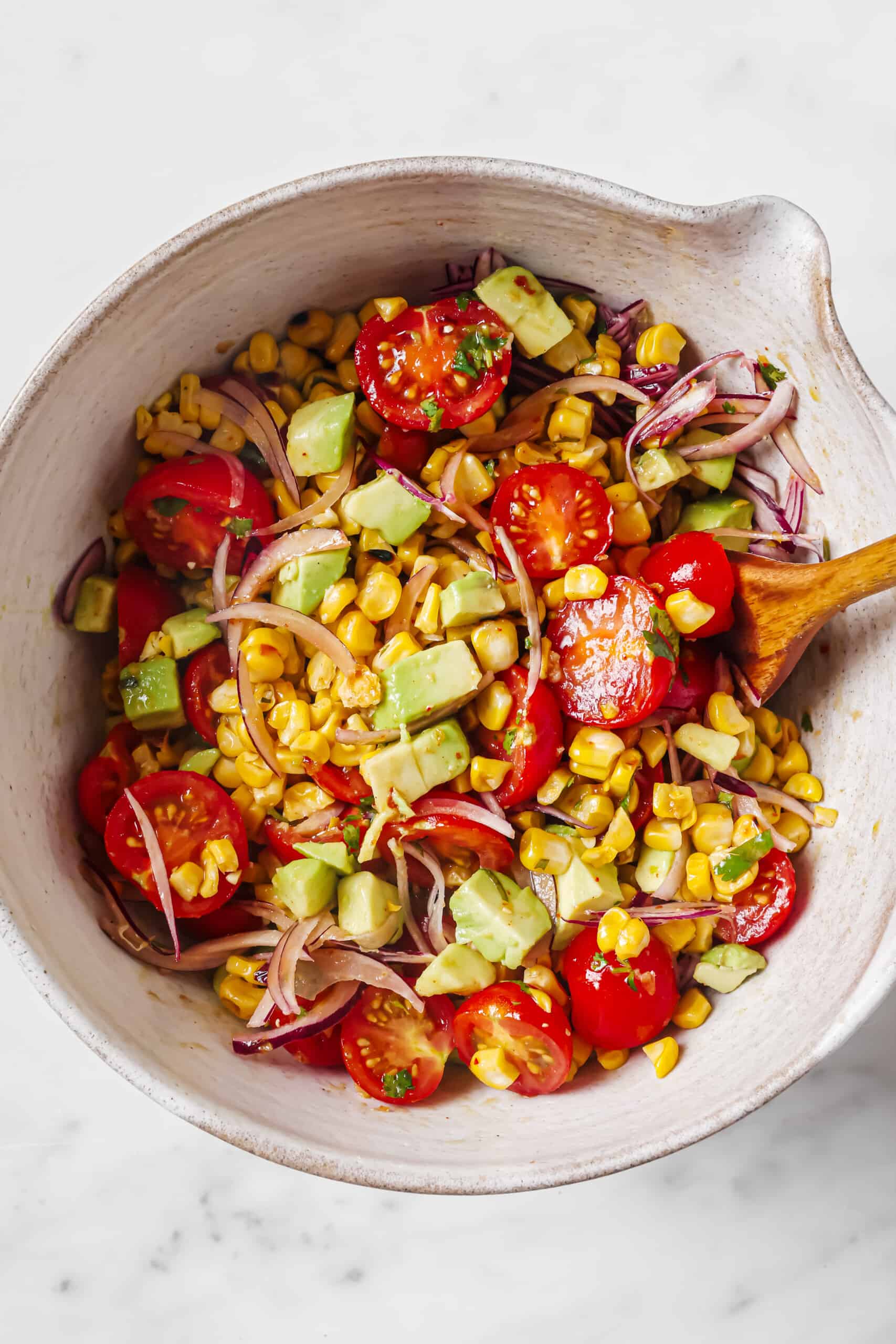 Mixing the salad ingredients.