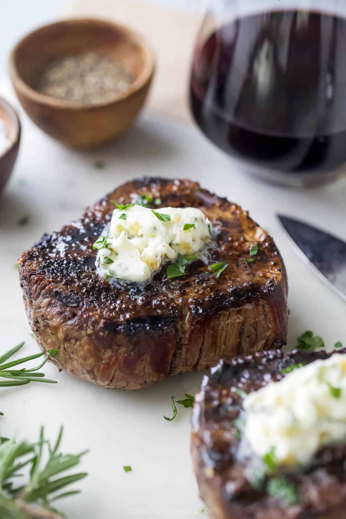 Grilled filet mignon with a ، of ،er on top.