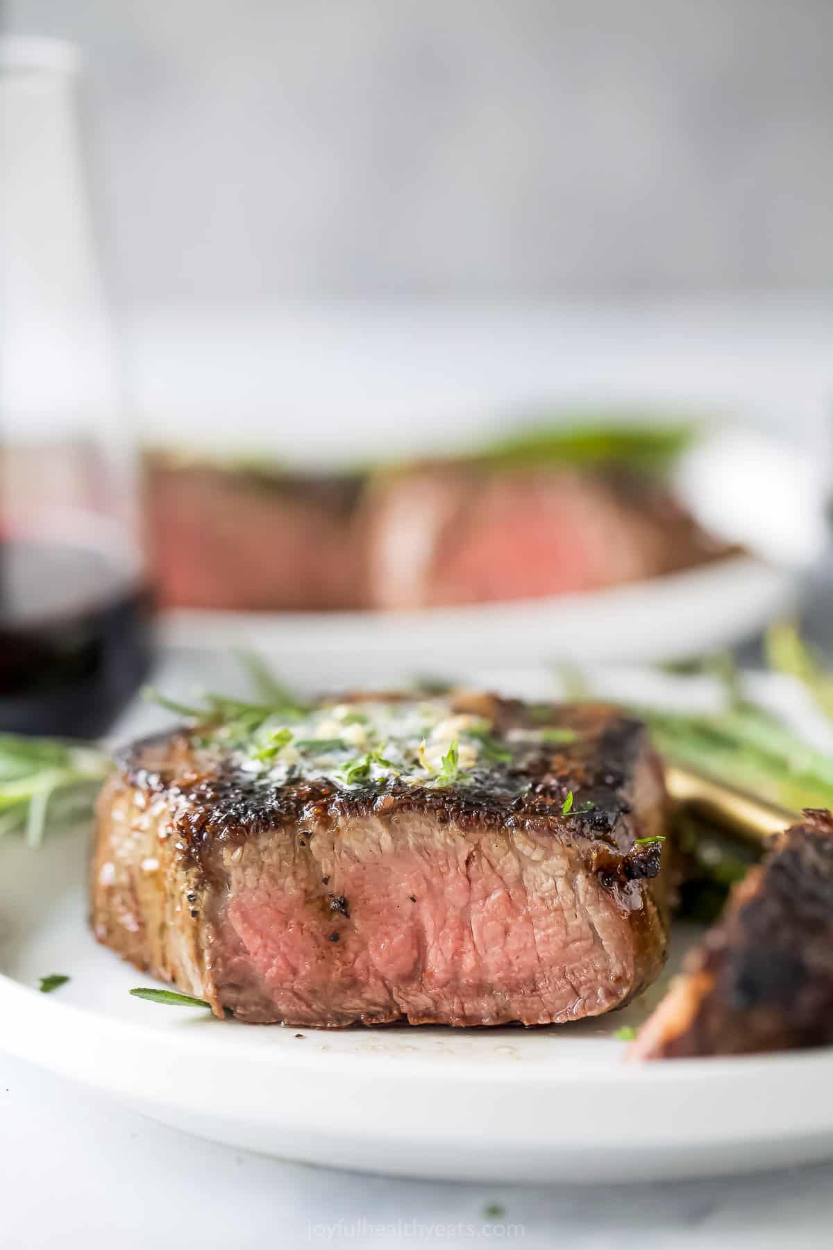 This 3-ingredient grilled filet mignon recipe is a juicy steak dinner you'll love for any weeknight or special occasions. Close-up of a sliced steak.
