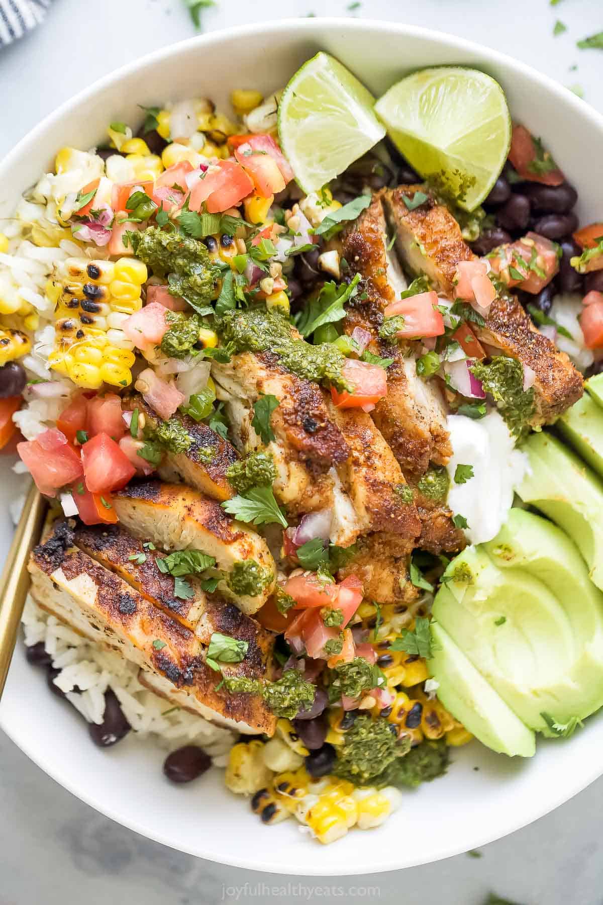Close-up of a chicken burrito bowl with toppings. 