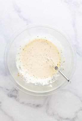 Whisked dressing in a bowl.