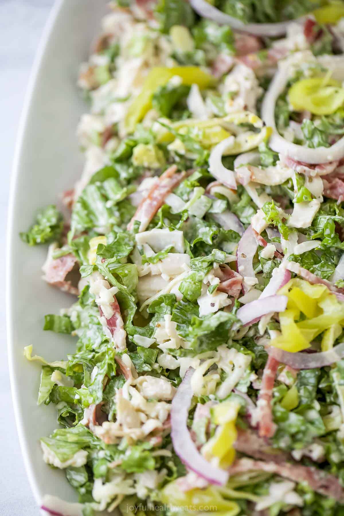 This easy Italian grinder salad recipe with homemade dressing is a trending 15-minute side that'll be a hit at the dinner table. Close-up of Italian grinder recipe with creamy dressing.