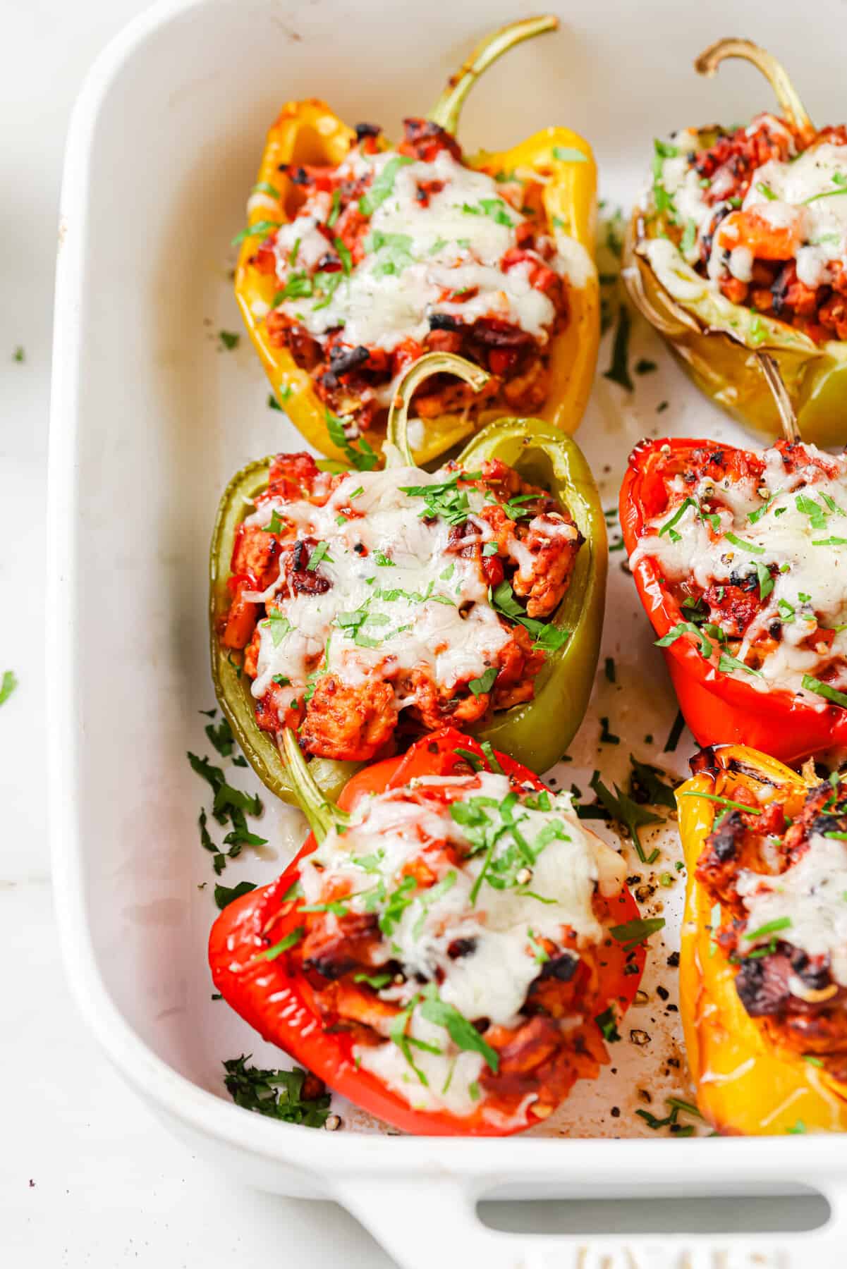 These Ground Turkey Stuffed Peppers are a simple dinner recipe filled with rich flavor your family will love. The perfect weeknight meal! Close-up of Italian stuffed peppers with ground turkey