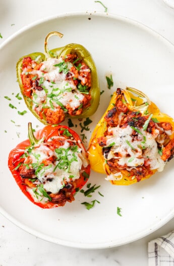 Three ground turkey stuffed peppers on a plate