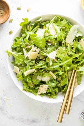 Angled photo of arugula salad recipe in a bowl.