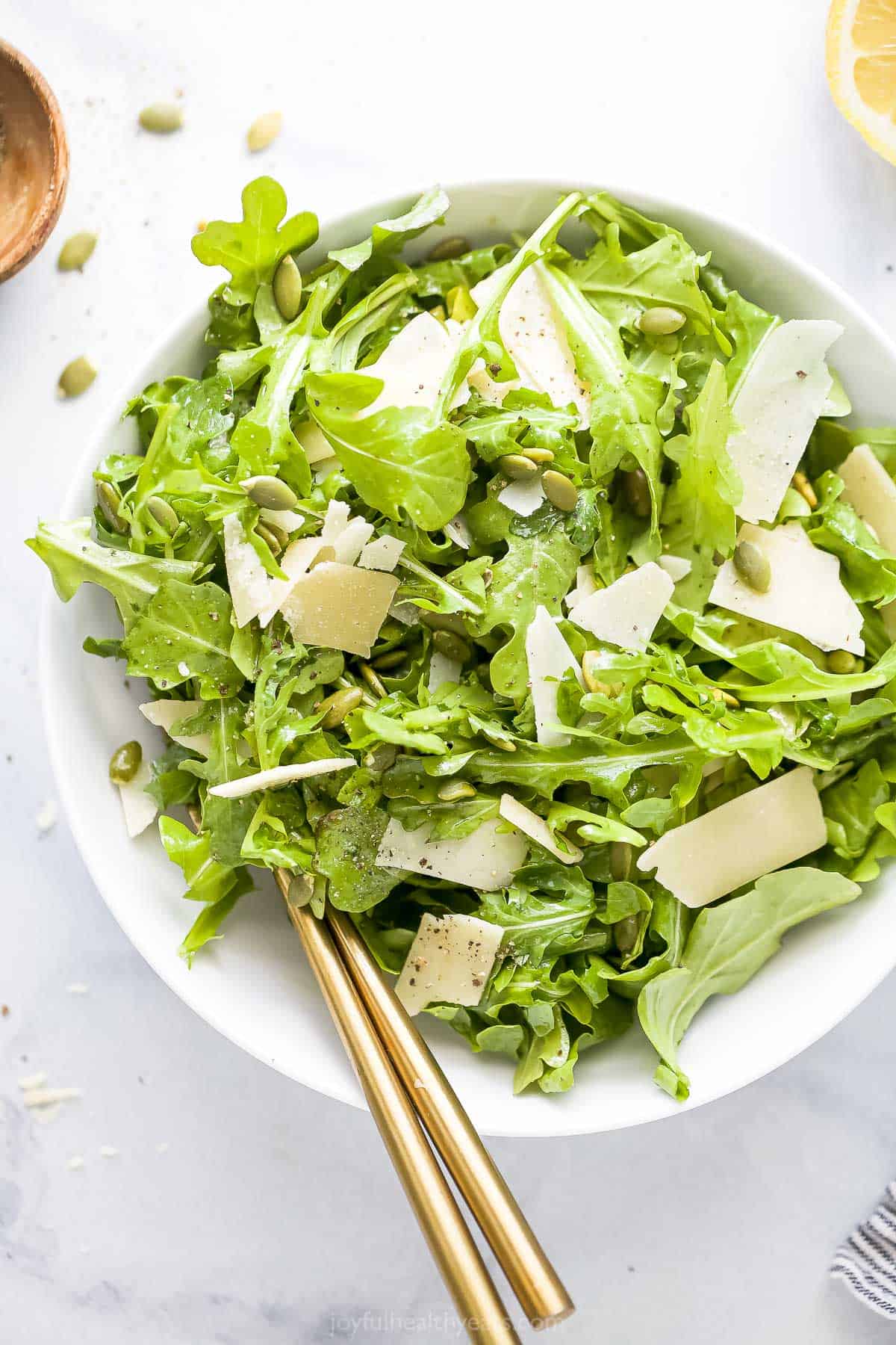 Photo of simple arugula salad in a bowl.