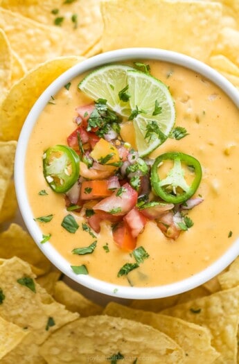 Bowl of chile con queso with pico de gallo.