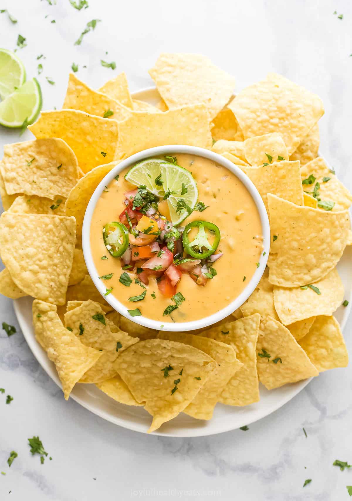 Bowl of chile con queso with pico de gallo. 