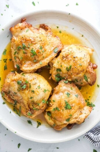 Four chicken thighs with honey garlic sauce.