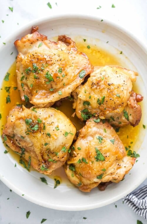 Four chicken thighs with honey garlic sauce.