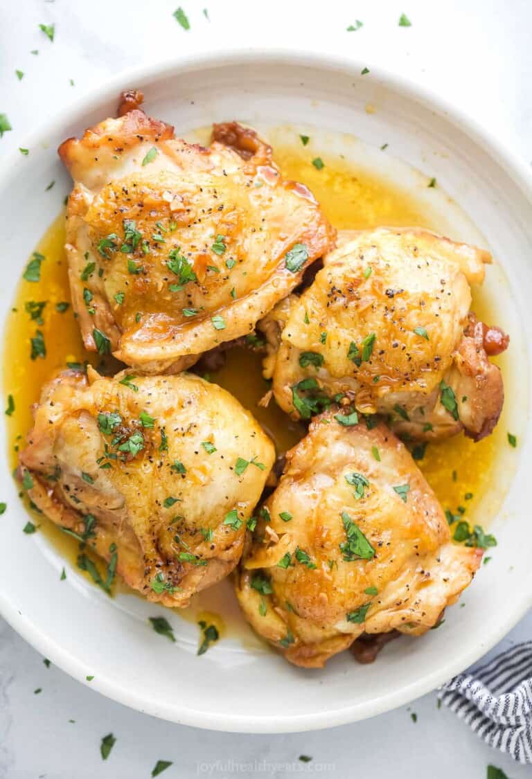 Four chicken thighs with honey garlic sauce.