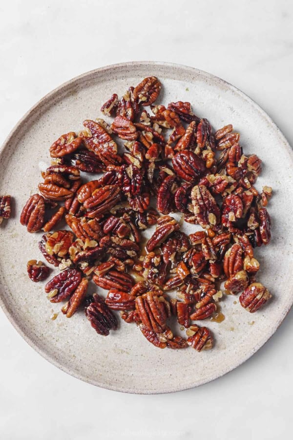 Candied pecans on a plate.