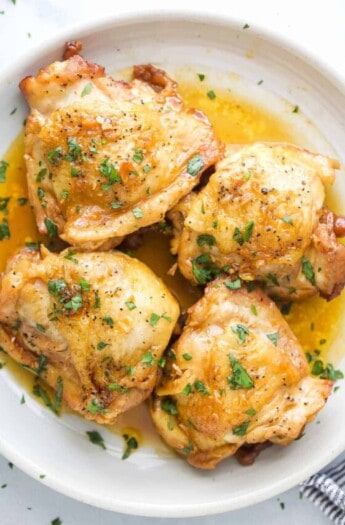 Four chicken thighs with honey garlic sauce.