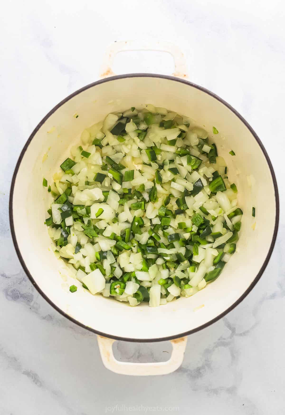 Adding the onions and poblanos. 