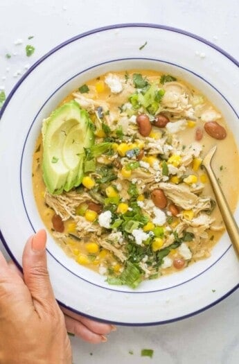 Bowl of creamy chicken chili with avocado.