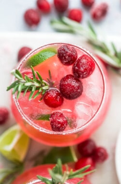 closeup overhead photo of a mistletoe margarita garnished with sugar cranberries