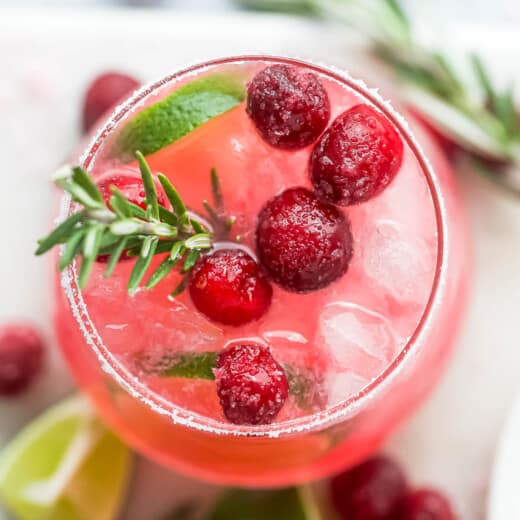 closeup overhead photo of a mistletoe margarita garnished with sugar cranberries