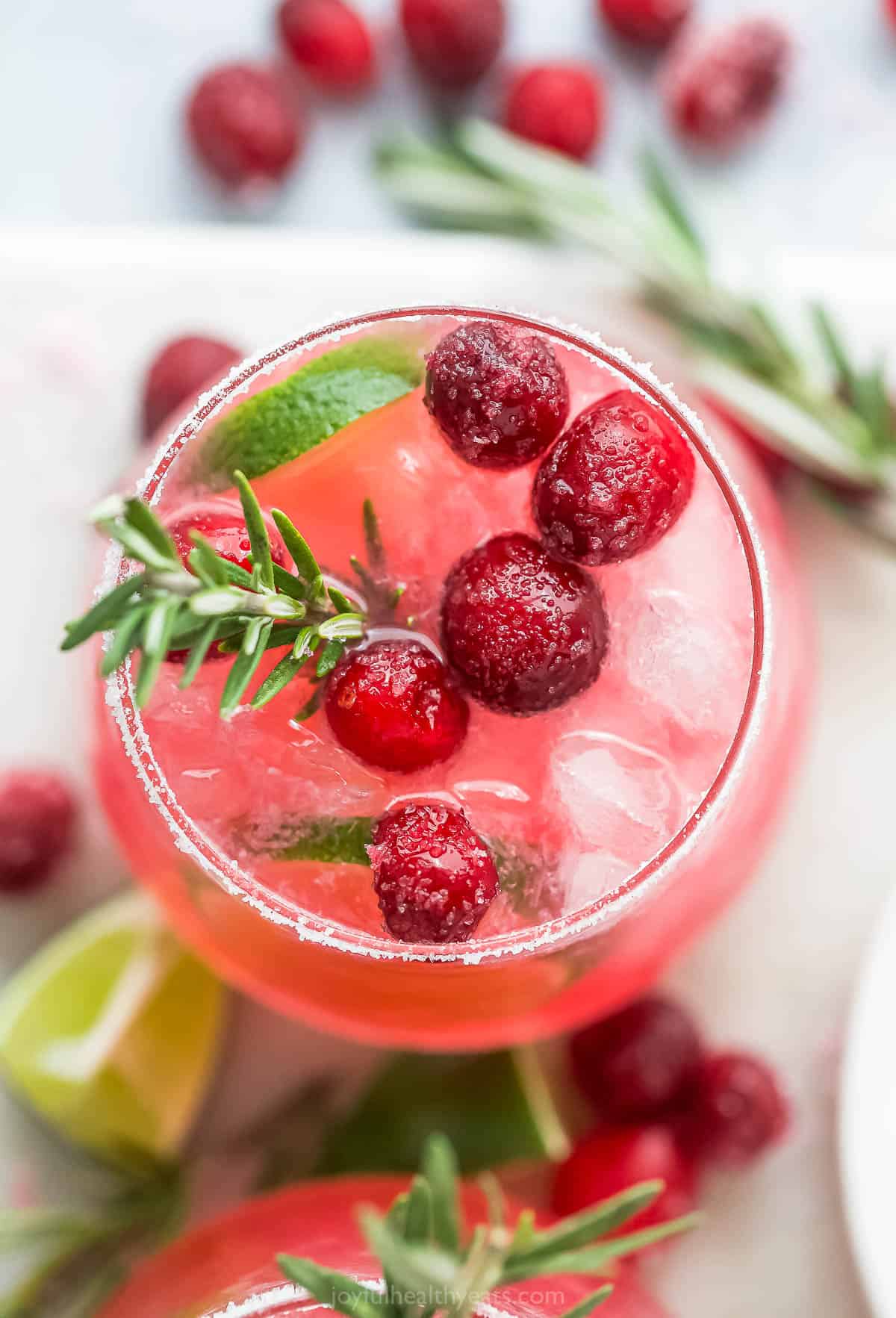 closeup overhead photo of a mistletoe margarita garnished with sugar cranberries