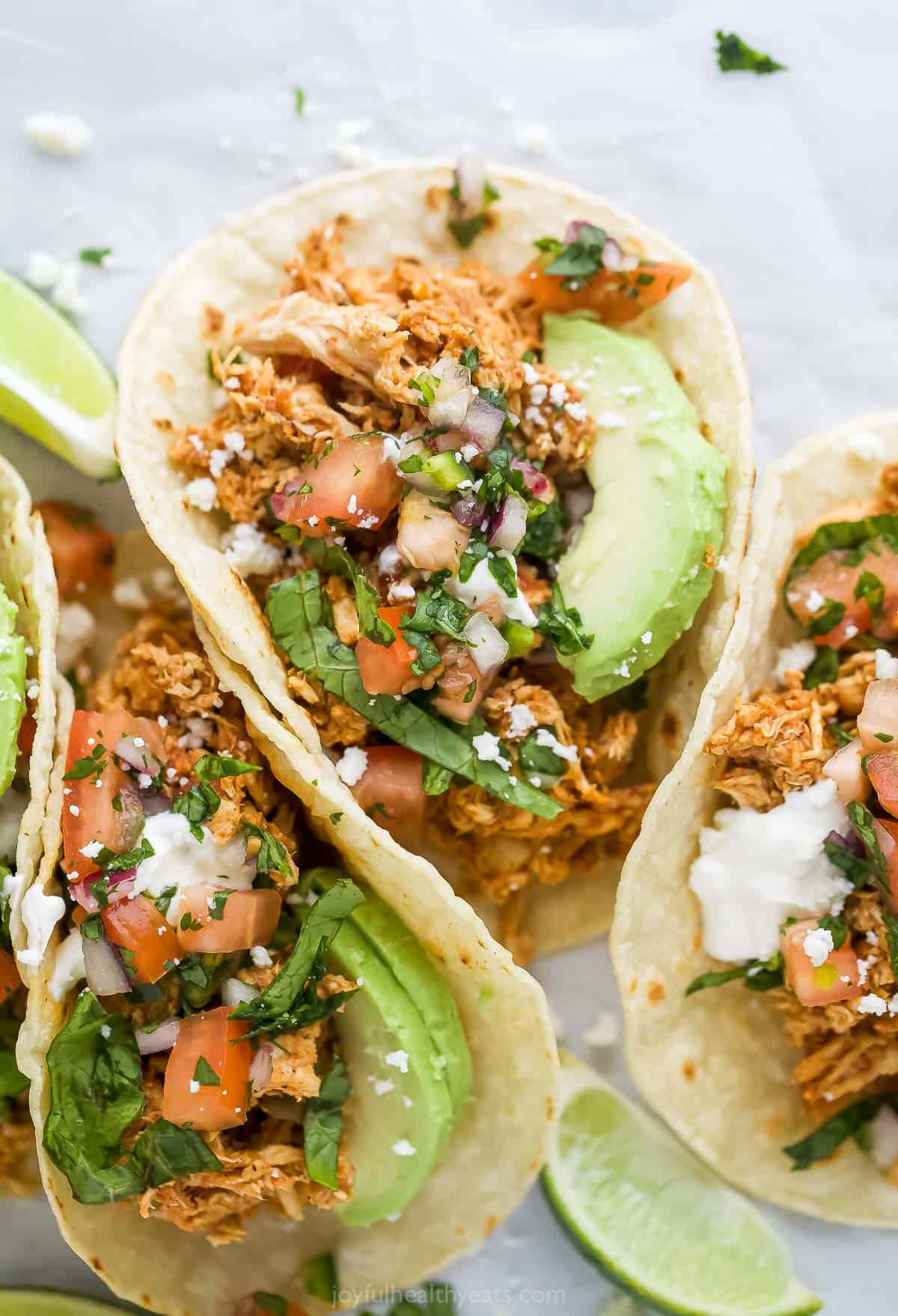 Rotisserie chicken tacos with avocado and pico de gallo. 