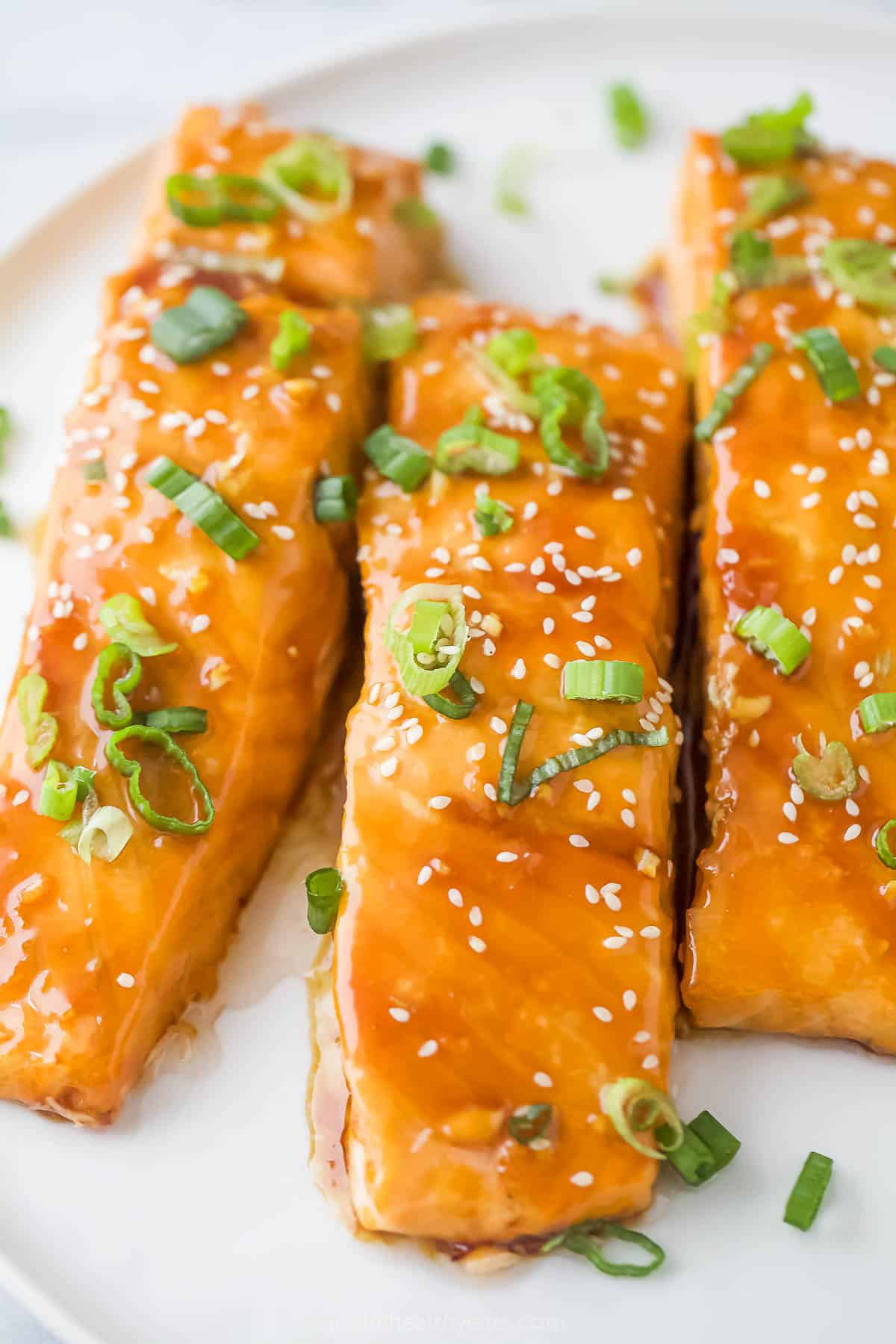 Three teriyaki salmon filets with homemade teriyaki sauce. 