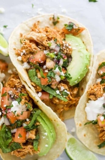 Rotisserie chicken tacos with avocado and pico de gallo.