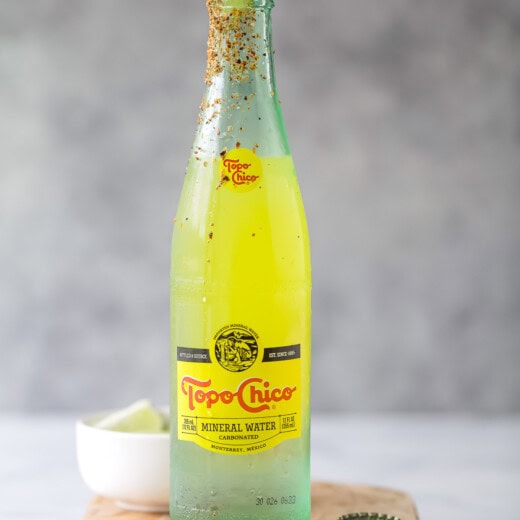 Ranch water recipe with a lime wedge and Tajin rim.