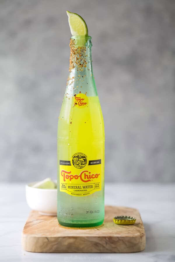 Ranch water recipe with a lime wedge and Tajin rim.