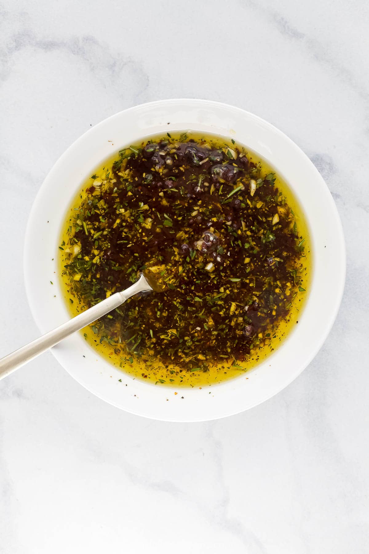 Bowl of bread dipping oil with spoon