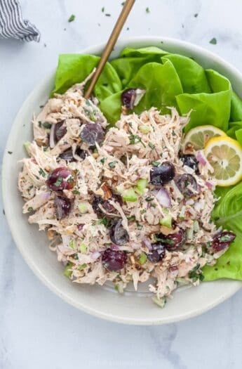 Overhead view of Waldorf chicken salad in bowl with lettuce