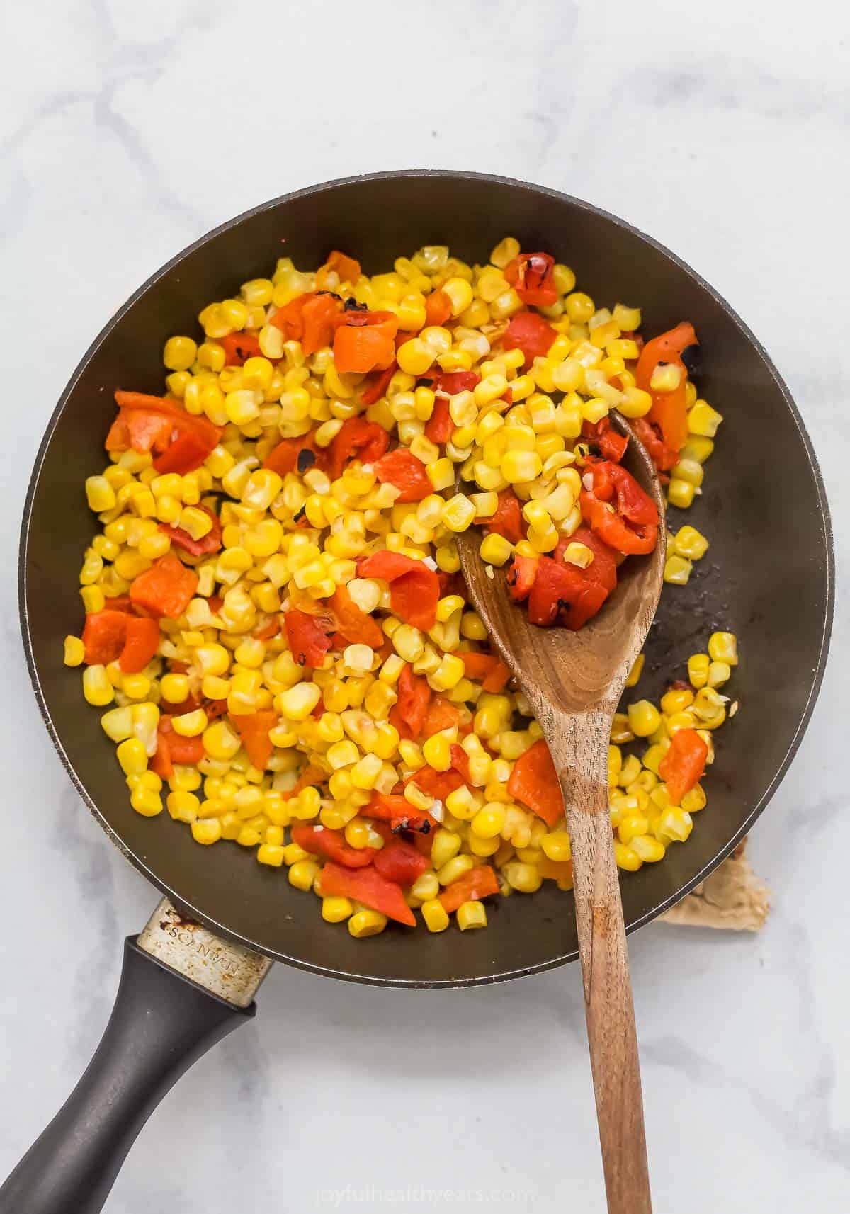 Overhead view of corn relish cooking in skillet