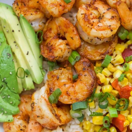 Overhead view of blackened shrimp bowl with avocado, rice, and corn relish