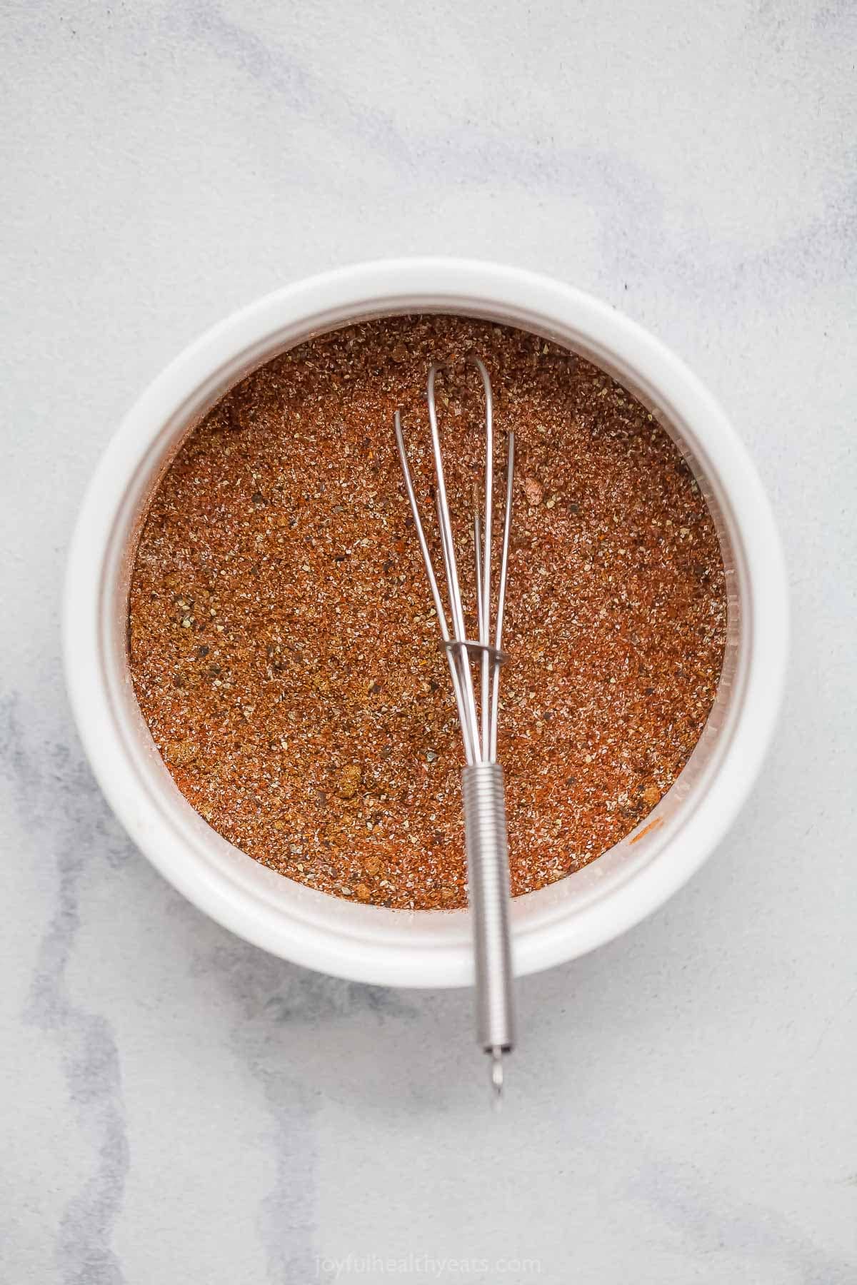 This Southwest Spice Blend is a multitasker, adding flavor to everything from shrimp and chicken to ribs. Smoky, savory and a bit spicy! Southwest spice blend in bowl with whisk