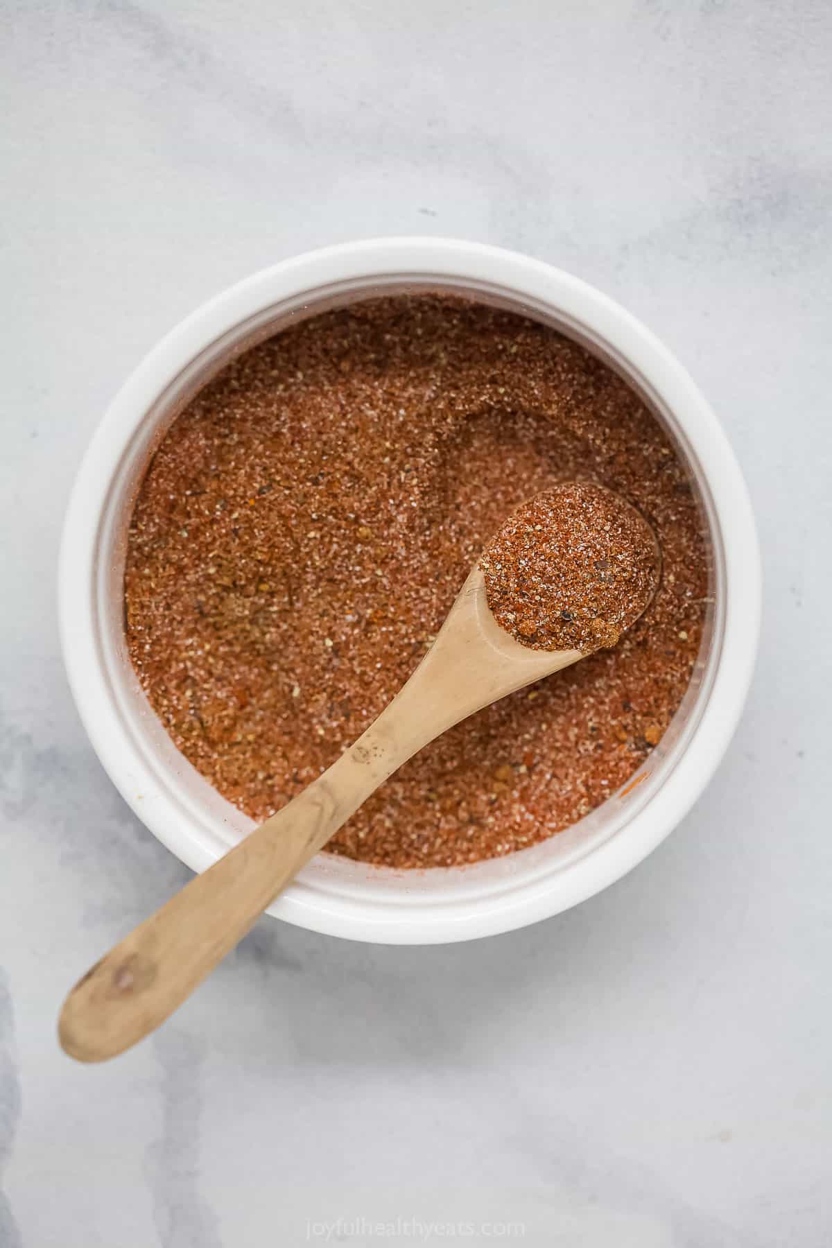 This Southwest Spice Blend is a multitasker, adding flavor to everything from shrimp and chicken to ribs. Smoky, savory and a bit spicy! Bowl of Southwest spice blend with spoon