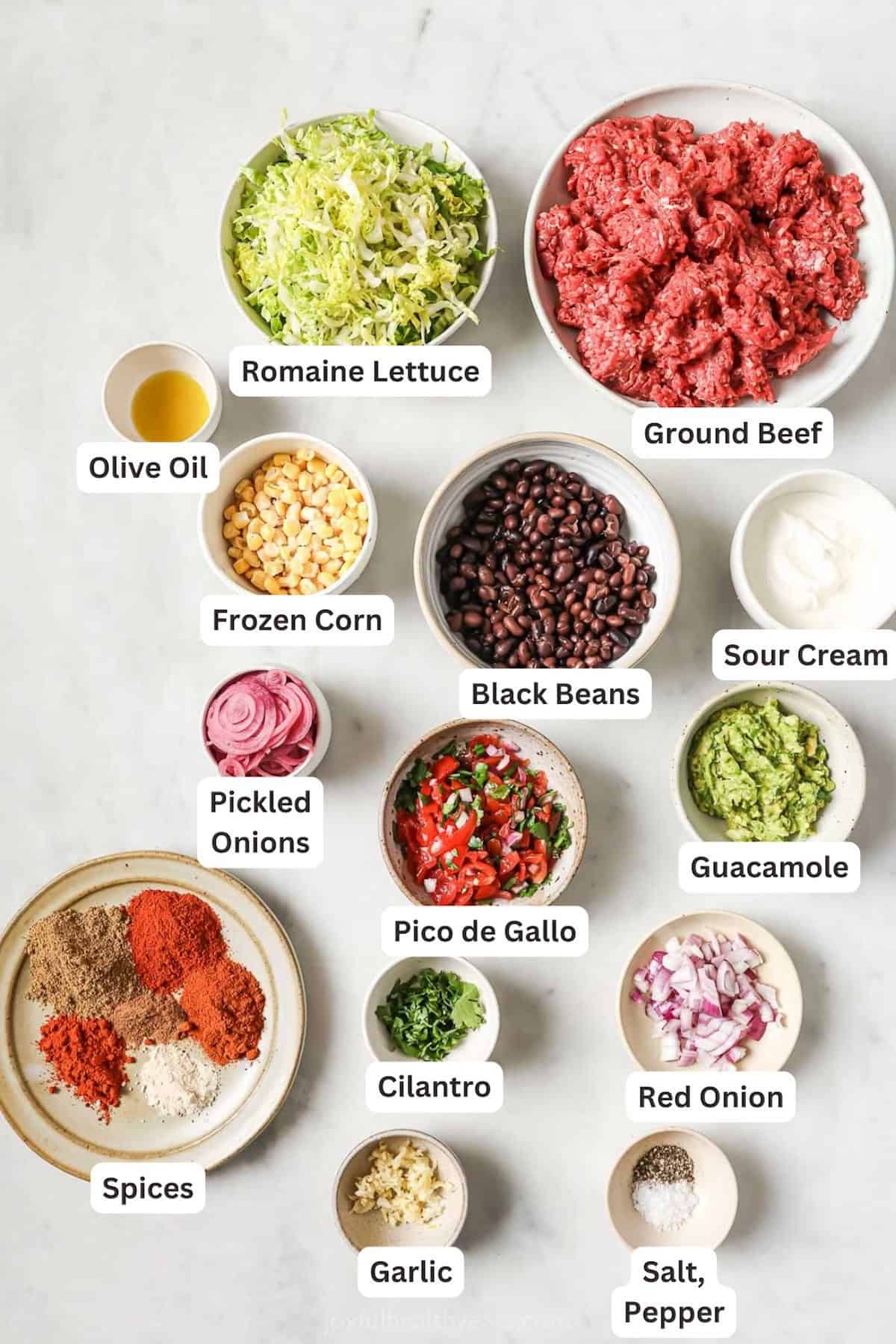 Overhead view of ingredients for taco salad bowls