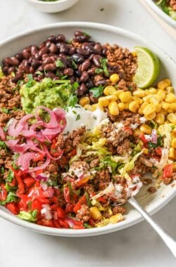 Taco salad bowl with black beans, beef, and corn