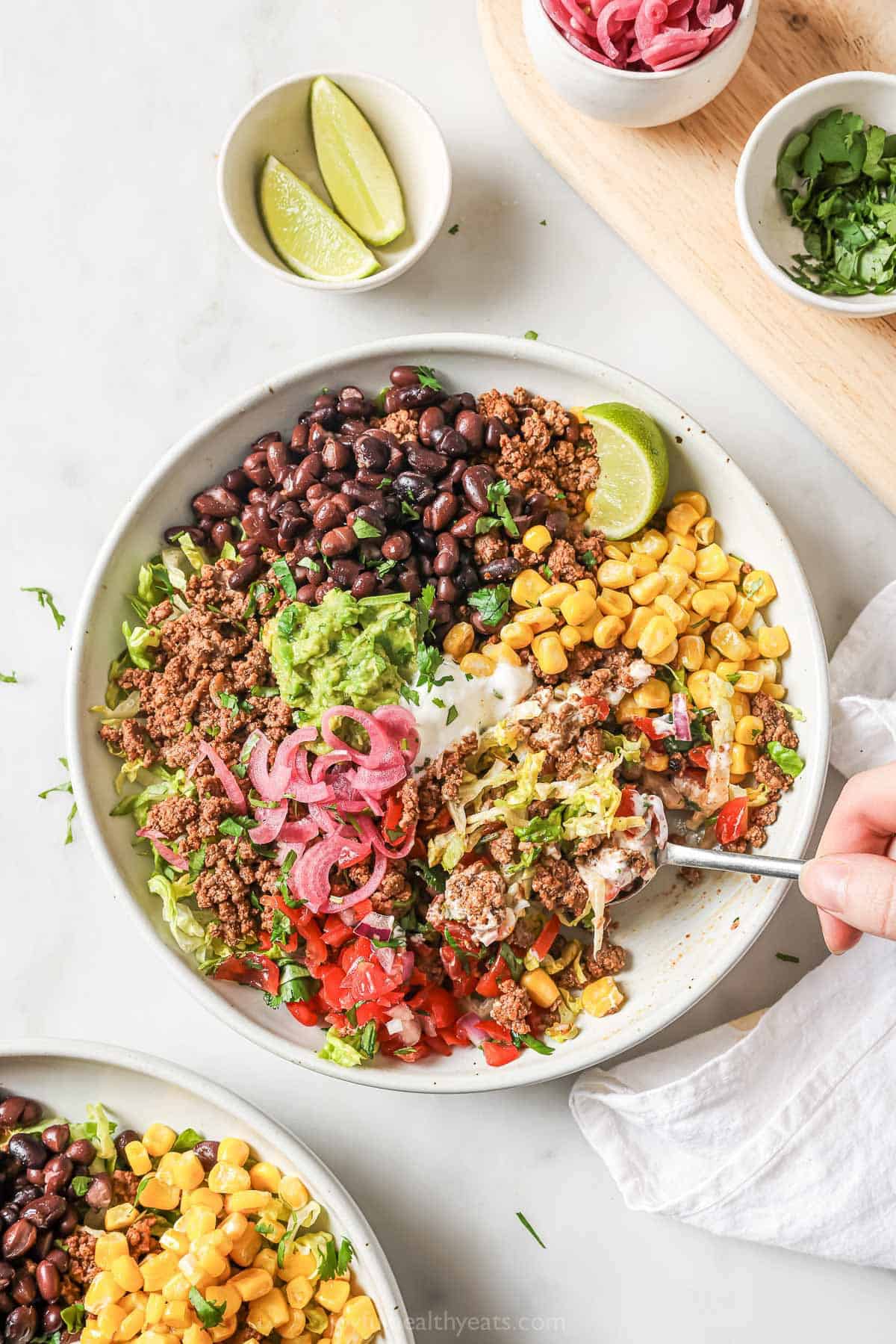 Overhead view of taco salad bowl with ground beef and sauteed corn
