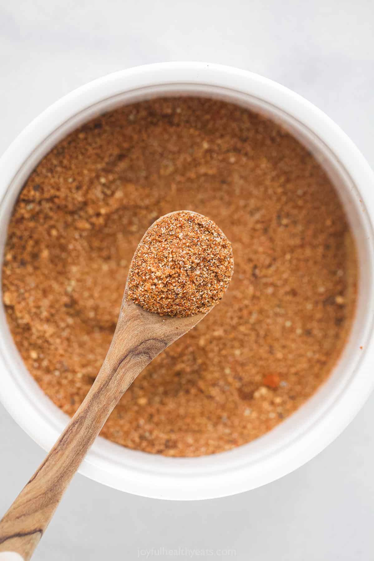 Spoonful of Buffalo chicken spice rub held over bowl