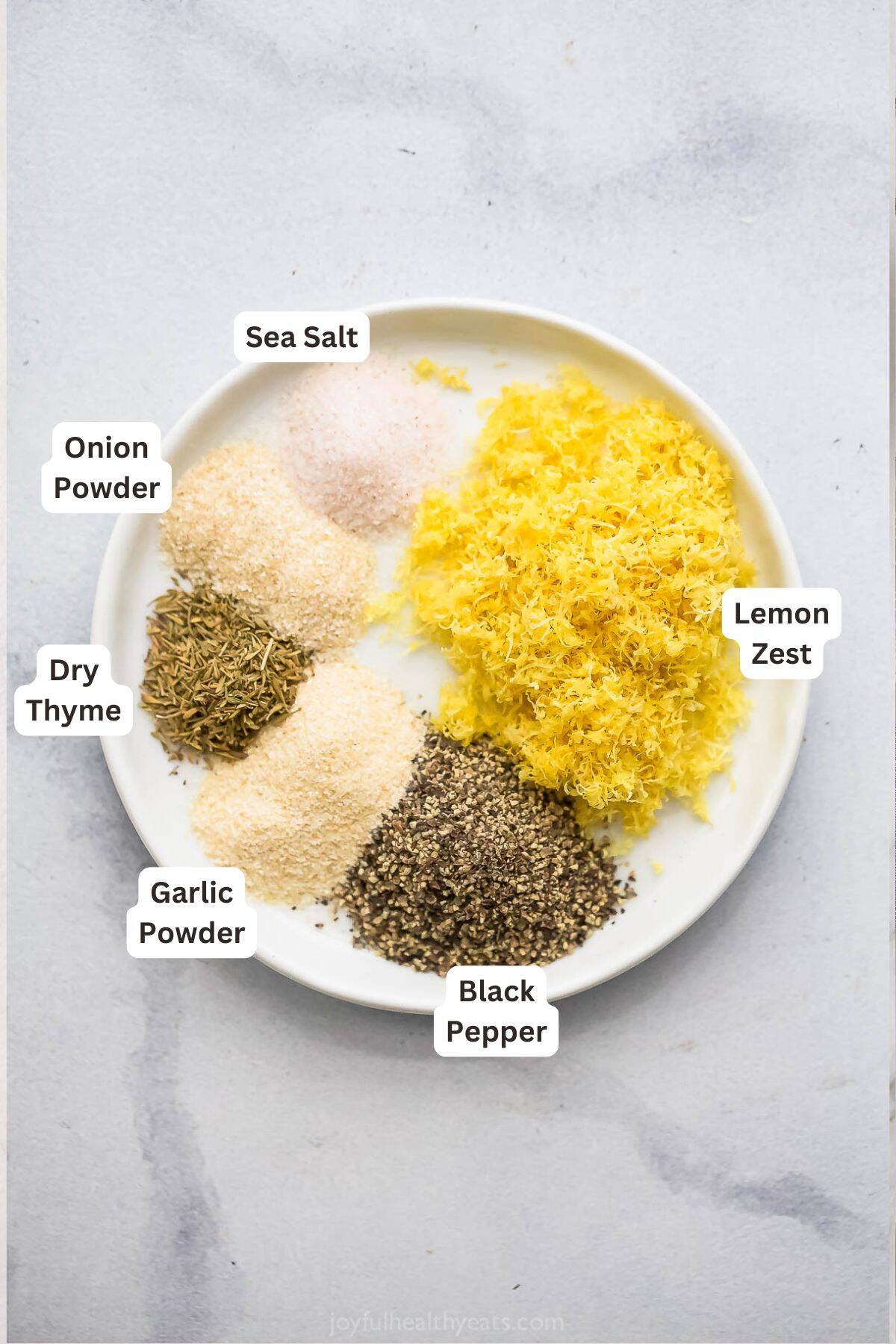 Add a pop of citrus to chicken, seafood, and more with this easy homemade Lemon Pepper Seasoning. It's so much tastier than store-bought! Overhead view of ingredients for lemon pepper seasoning