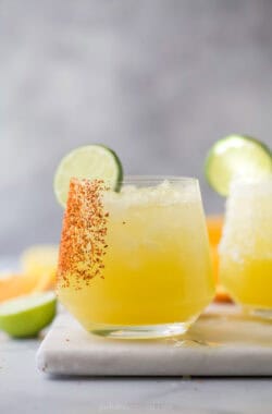 Closeup of mocktail margarita with lime wheel and tajin