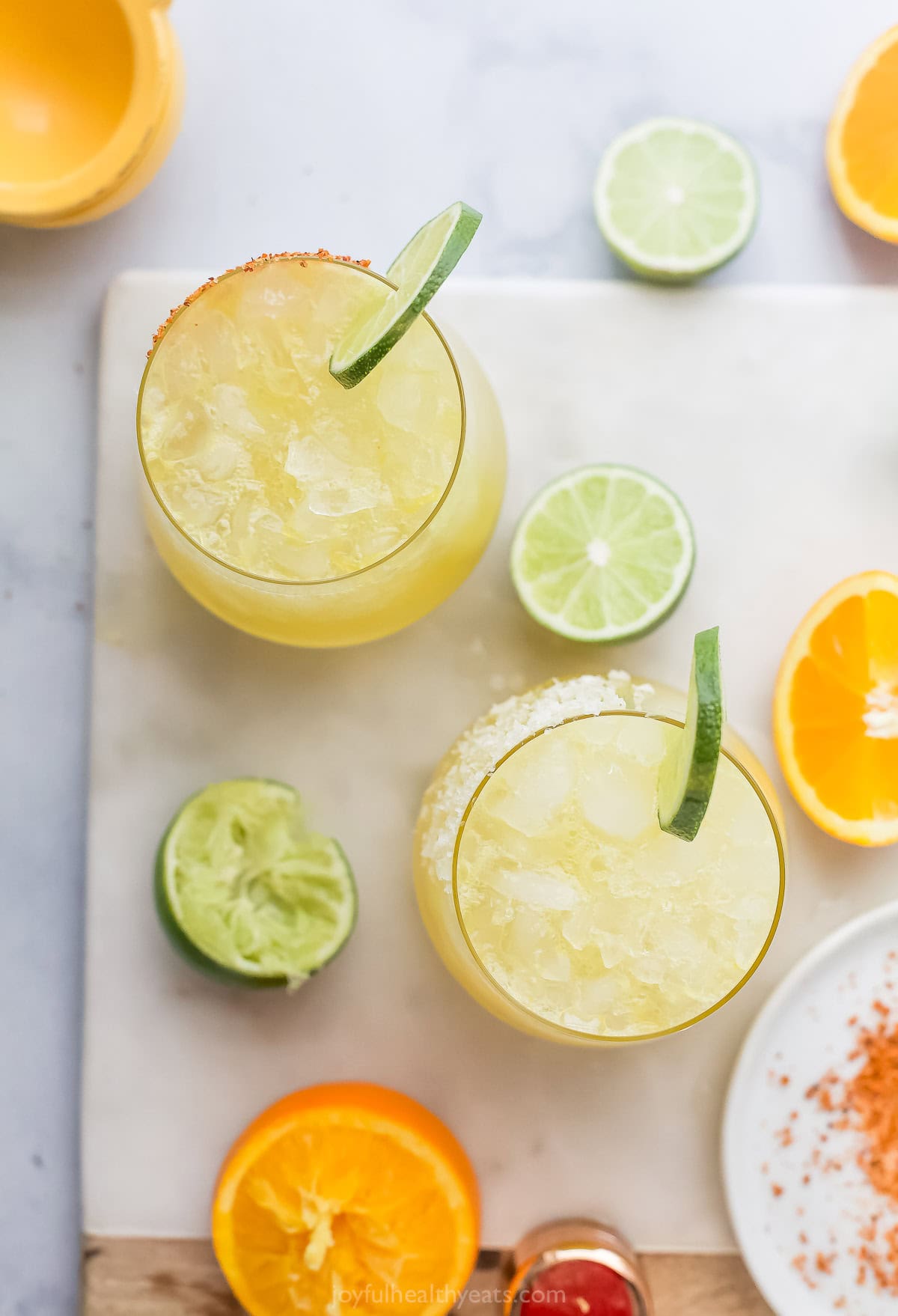 This Margarita Mocktail recipe is made without the alcohol but ALL the flavor, with a blend of fresh citrus juice, agave and sparkling water. Overhead view of margarita mocktails in 2 glasses with lime wheels
