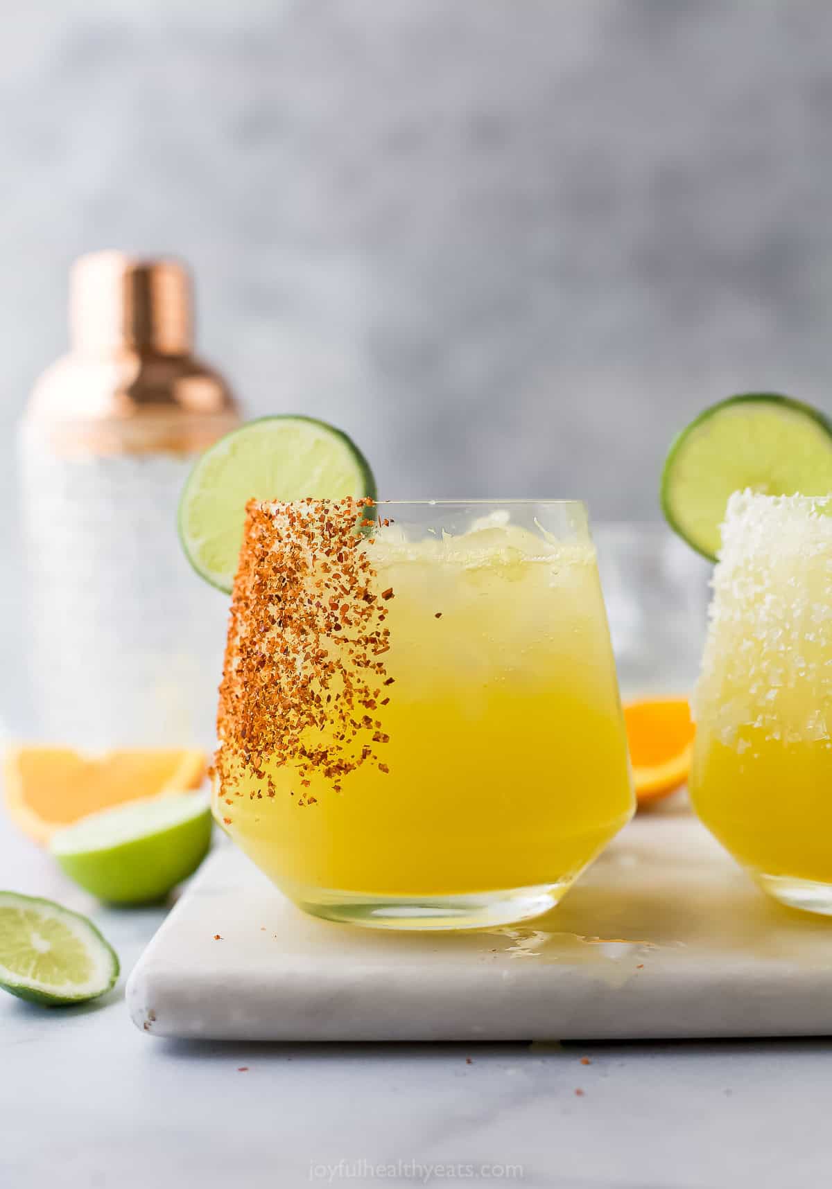 This Margarita Mocktail recipe is made without the alcohol but ALL the flavor, with a blend of fresh citrus juice, agave and sparkling water. Side view of margarita mocktails in glasses with salt and tajin