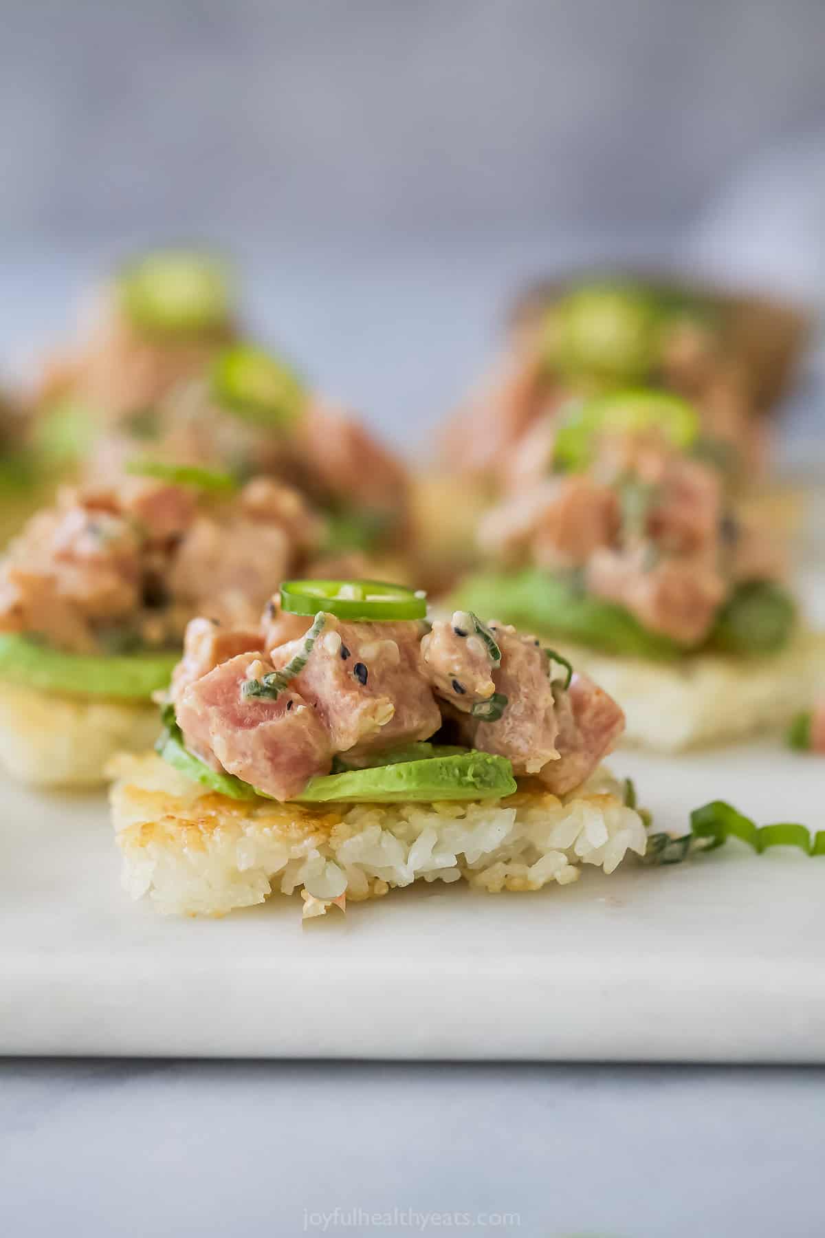 This Spicy Tuna Crispy Rice is a Nobu copycat that’s sure to impress! It’s easy to make, with ahi tuna topping crispy cubes of sushi rice. Copycat spicy tuna crispy rice bite