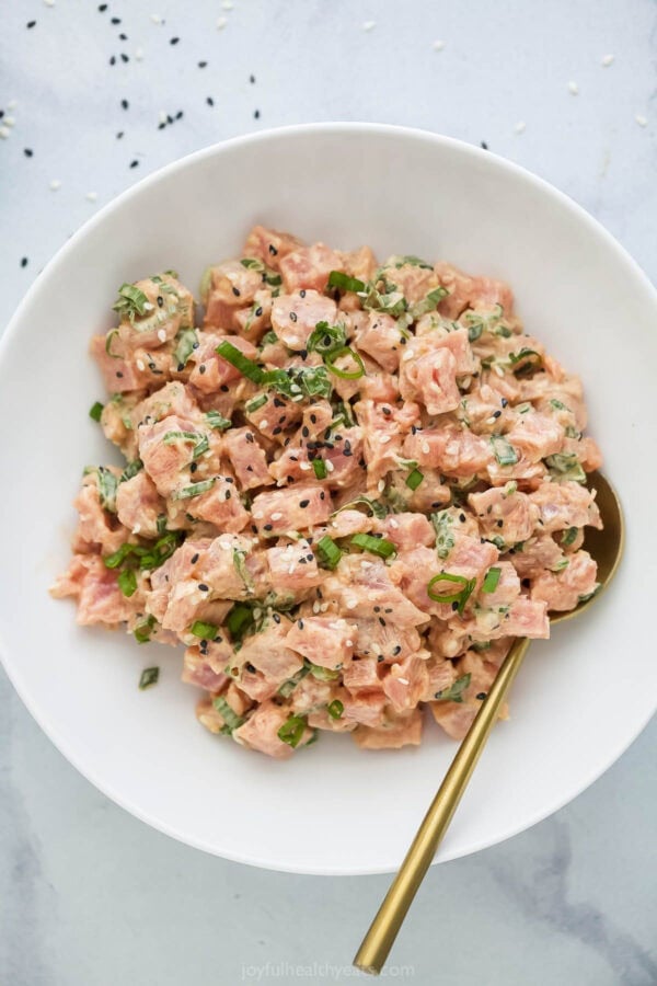 Bowl of spicy tuna with gold spoon