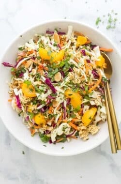Overhead view of ramen noodle salad in bowl with gold spoons