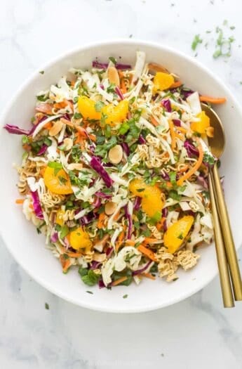 Overhead view of ramen noodle salad in bowl with gold spoons