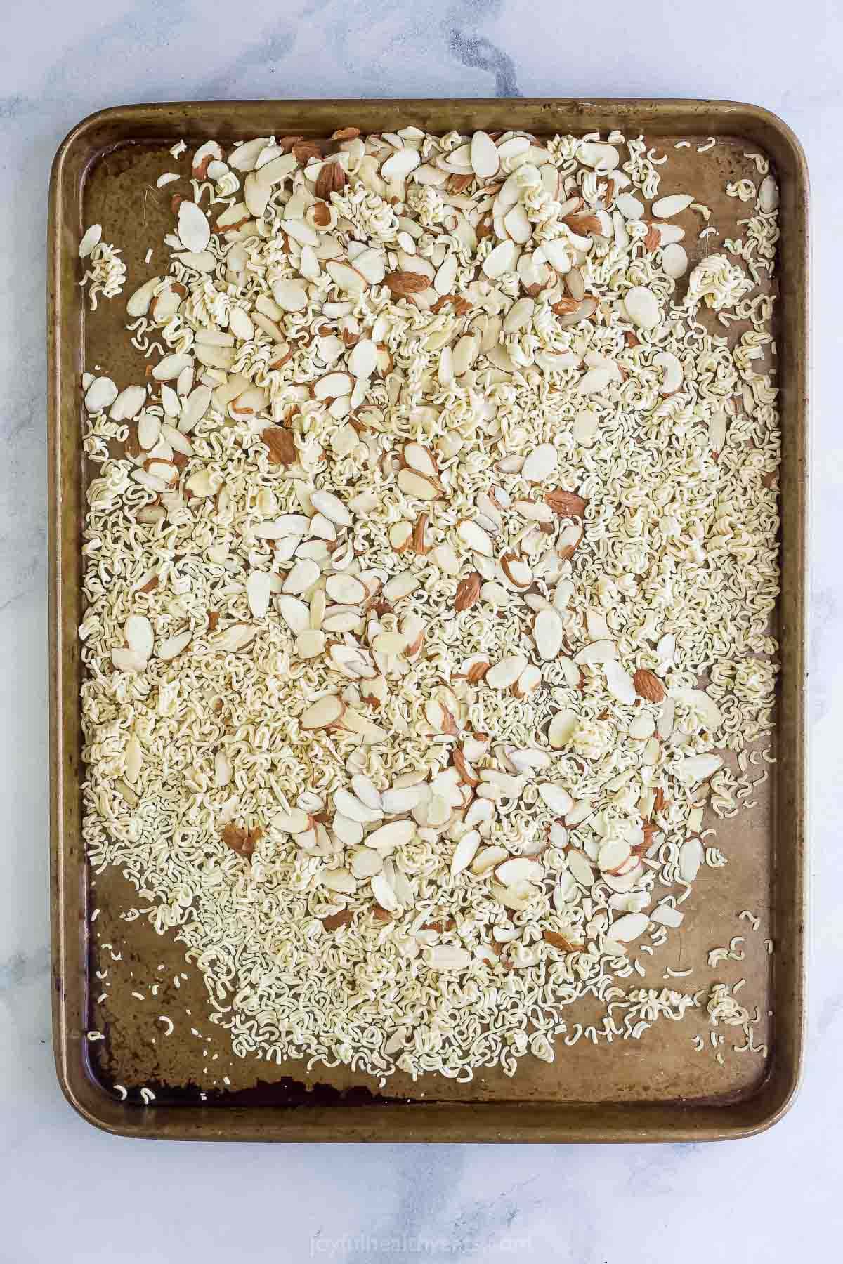 Crunchy, crisp, and sweet Ramen Noodle Salad is a classic! I’ve given it a more modern spin, but it still has that familiar flavor you love. Overhead view of ramen and almonds on sheet pan
