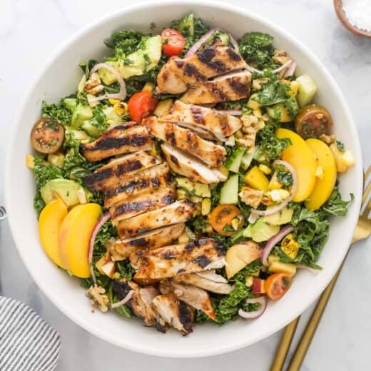 Overhead view of summer salad recipe with corn and peaches