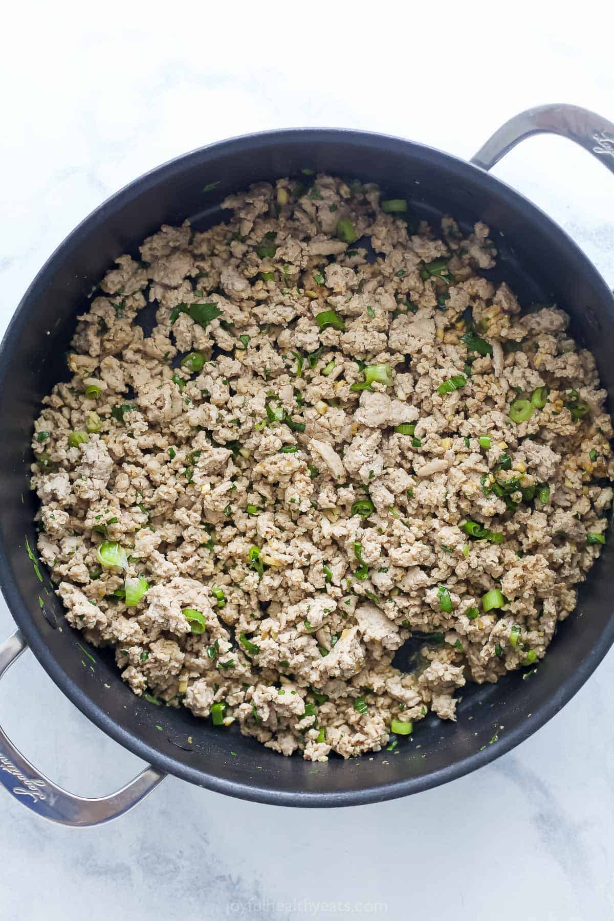 Overhead view of ground turkey cooked in deep skillet