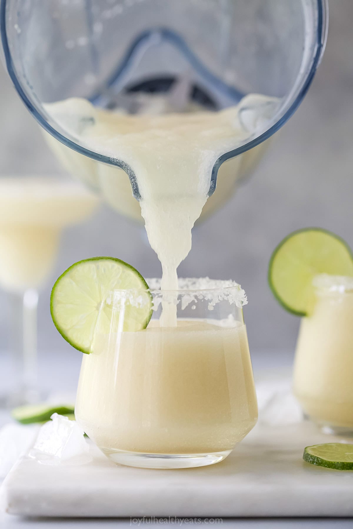 Pouring frozen margarita into glass