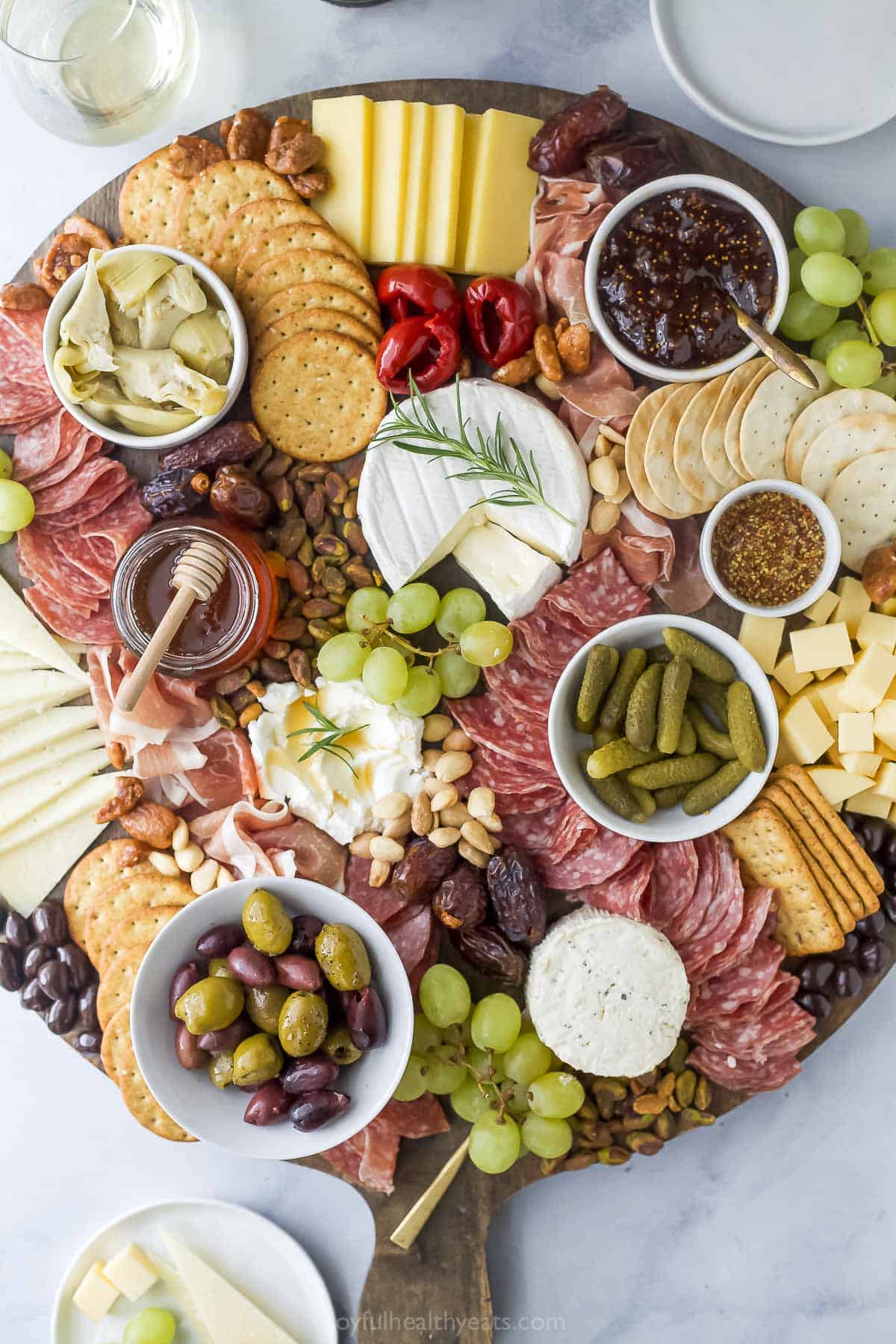Overhead view of charcuterie board with meats, cheeses, and fruit